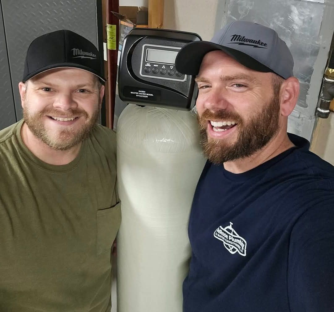 DeRose Plumbing team in front of a water treatment system